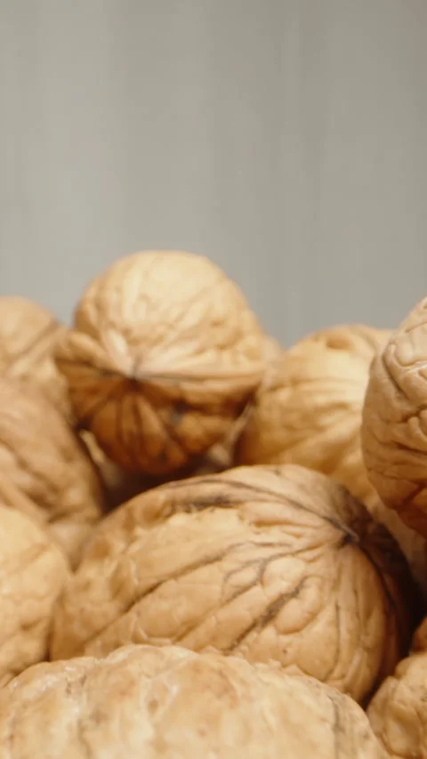 A scattering of walnuts on a white background. Dolly slider extreme close-up. Ve Stock Footage 245947461