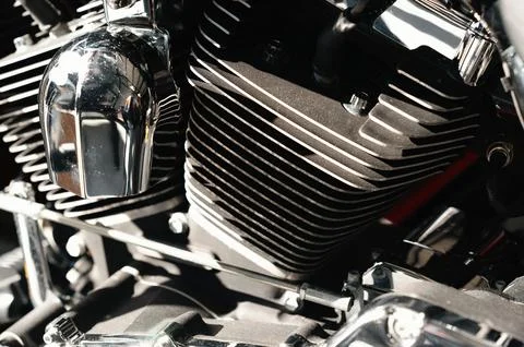 Scenario showcasing test rider inspecting mechanical chrome engine fin with Stock Photos