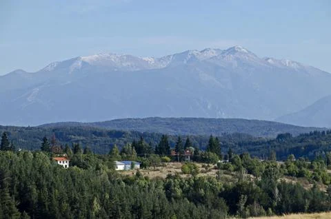 Scene with autumn meadow, forest and residential district of the Plana village Stock Photos