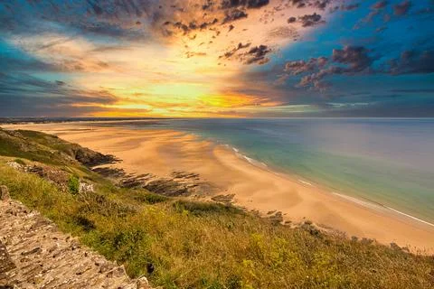 Scene of beach side with cloudy sky, saturated colors Stock Photos