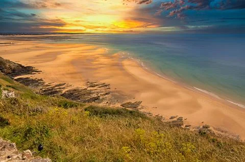 Scene of beach side with cloudy sky, saturated colors Stock Photos