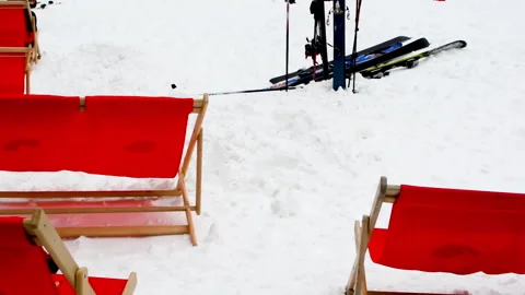 A scene at the bottom of ski station with sun chairs. Video stock 152689113