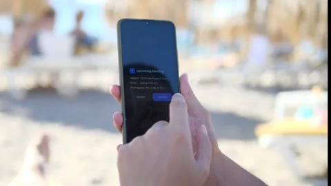 The scene captures a person joining a video conference audio-only from a beach 스톡 동영상 318580921