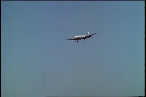 Scene of DC-6 and C-54 come in over apartments and landing singly - 1961 Stock Footage 101166820