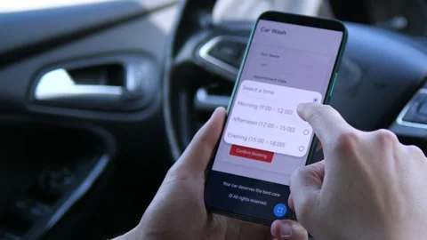 The scene demonstrates the seamless process of booking a car wash through a Stock Footage 318721241