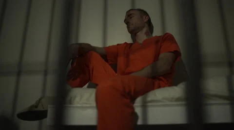 Scene of a depressed and tattooed inmate in prison Stock Footage 59763383