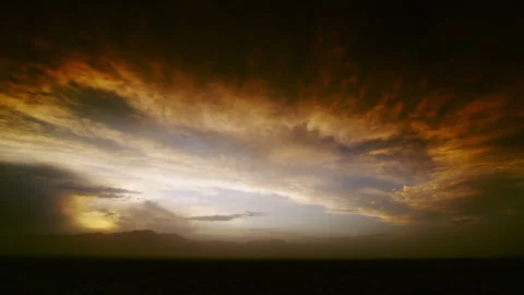 Scene at dusk with distant mountains blanketed with smoke from distant fires. 動画素材 281918490