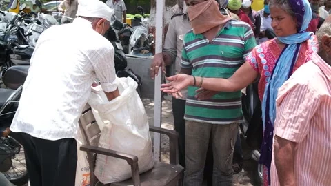 Scene from the front where NGO workers are delivering free food parcels to Stockbeeldmateriaal 246679731