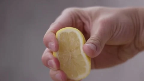 Scene of hand squeeze fresh lemon juice. Squeezing out fresh Lemon juice dr.. Stock Footage 265840186