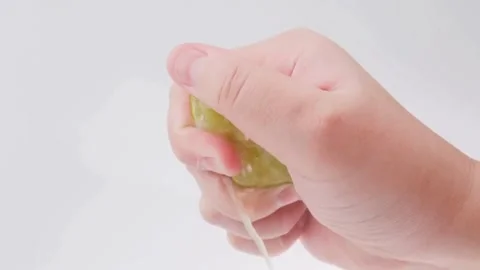Scene of hand squeeze fresh lemon juice. Squeezing out fresh Lemon juice dr.. Stock Footage 265841218