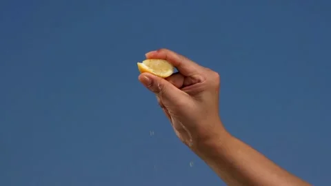 Scene of hand squeeze fresh lemon juice. Squeezing out fresh Lemon juice drains Stock-Footage 336588777