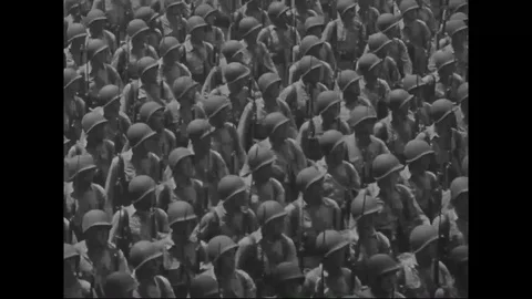Scene of hundreds of U.S. troops and soldiers marching down city street - 1940 Stock Footage 106620541