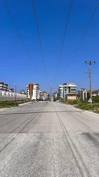 . The scene includes a clear blue sky and buildings lining the street. Stock Photos