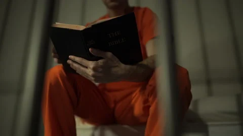 Scene of an inmate reading a bible in prison Stock-Footage 59764035