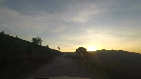 A scene from inside the car on a difficult mountain road at sunset Video stock 149045566