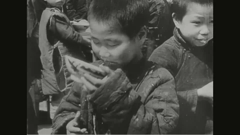 Scene of a little boy eating while clothes distributed among children Vídeo Stock 99097628