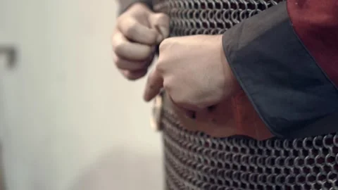 Scene of a medieval warrior donning his armor and accessories, preparing Stock Footage 320146277