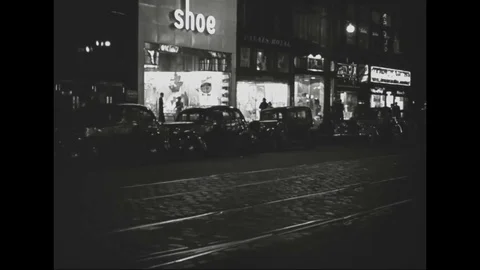 Scene of neon signs on stores in the downtown at night - 1939 Stock Footage 101736632
