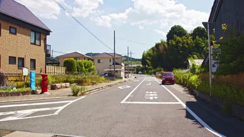 A scene with an old type of red postbox in a rural town Video stock 134222593