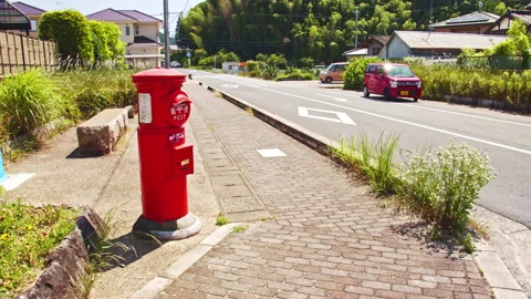 A scene with an old type of red postbox in a rural town in Nara Stock Footage 134222711
