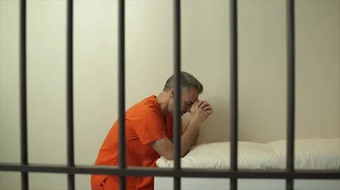 Scene of a prayerful inmate in prison Stock Footage 59761068