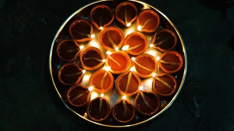 A scene of profound serenity unfolds, where numerous earthen lamps, nestled with Stock Footage 321861670