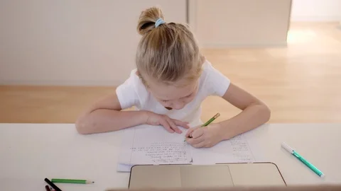 A scene from real life, a boy in lockdown is doing homework. He thought for a se Stock Footage 128086240