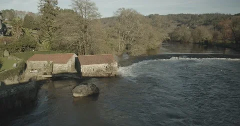 Scene of a River mill and small waterfall on winter time Video stock 137228739