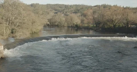 Scene of a river with small waterfall on winter time Видео 137228611