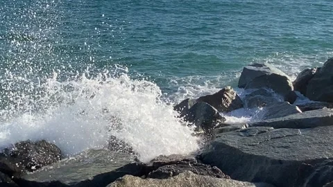 Scene of sea waves in front of a rocky beach Stock Footage 335582260