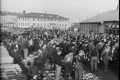Scene of several workers and a man as he buys and reads the newspaper - 1951 Stock Footage 99097523