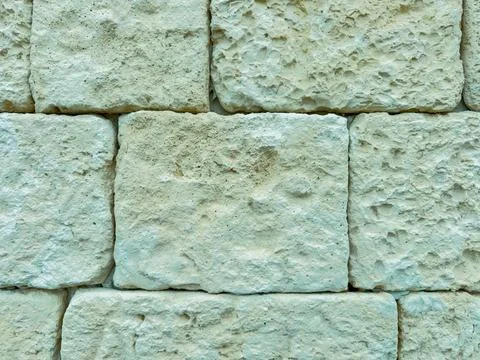 The scene shows rough stone blocks stacked in a regular pattern. The light co 库存照片
