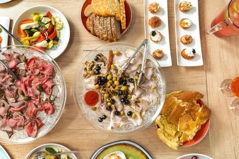 Scene of a table with appetizers. Top view on white wooden background. Board Stock Photos