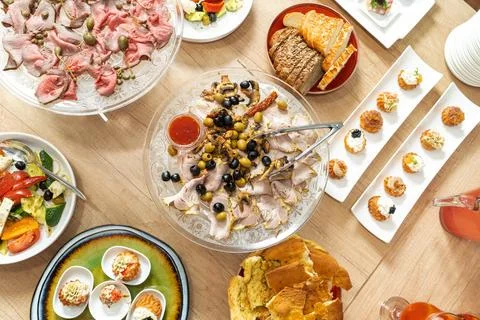 Scene of a table with appetizers. Top view on white wooden background. Board Stock Photos