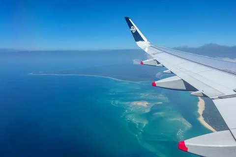 Scene through plane window Air New Zealand wing and wingtip above Queenslan.. Stock Photos