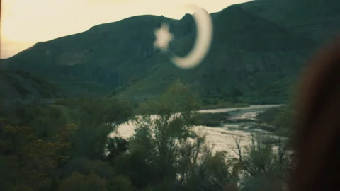 A scene from the train journey: A tranquil river winds its way through a verdant Vídeos de archivo 335463449