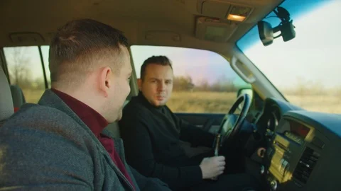 Scene of two men ride in a car with bottles of alcohol, they drink alcohol while Stock Footage 121621650