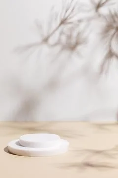 Scene with white podium on beige background and shadows Stock Photos