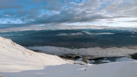 Sceneic view from a snow covered mountain top over looking the city Stock Footage 100054063