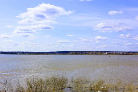 Scenery. boat on the river, trees, sky with clouds. A beautiful green valley Stock Photos