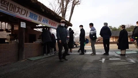 The scenery in front of the ticket booth with people waiting in line Stock Footage 250944707