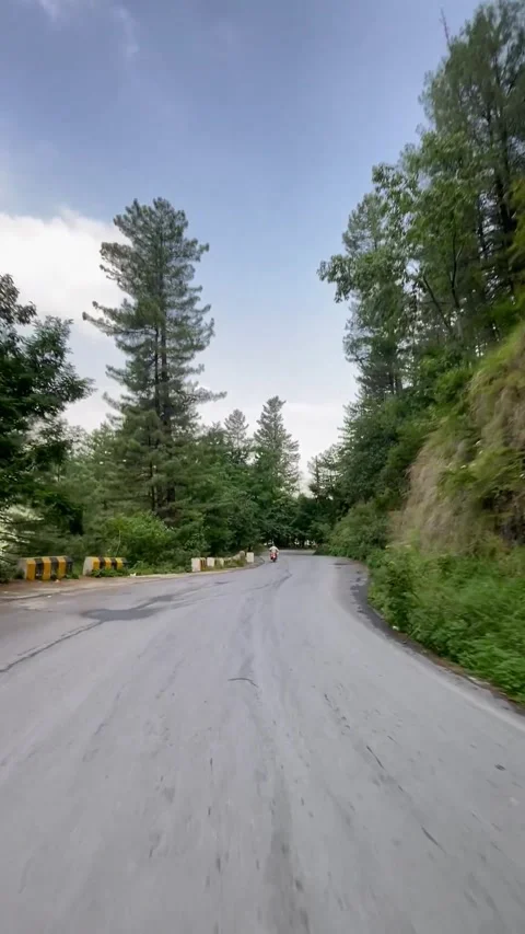 Scenery of greenery at Blue sky with this neat and clean road with mountains,  스톡 동영상 343613233