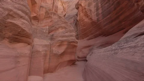 Scenery of the narrow path between sandstone dunes with sun beams above rocks Stock Footage 169674314