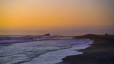 Scenery of ocean with sea waves hitting beach at sunset Stock Footage 133376752