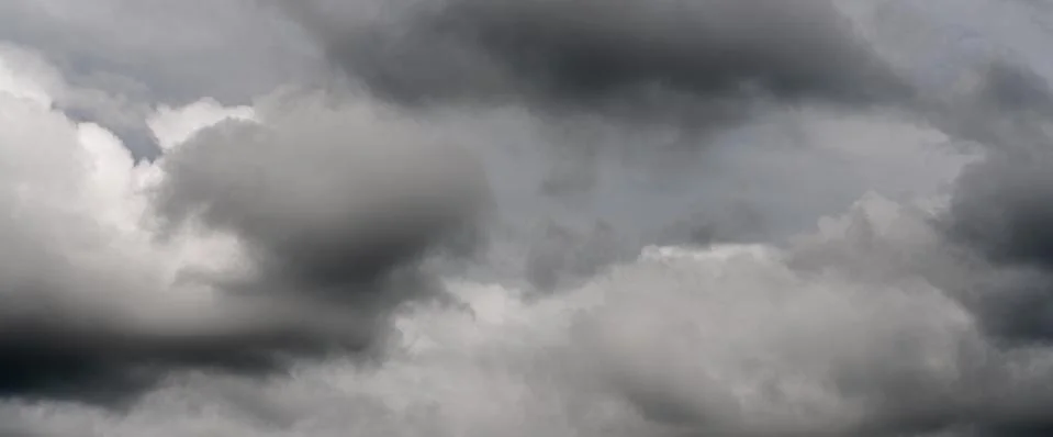 Scenery panoramic view of thunderstorm clouds in dusk sky during rain. Dramatic Stock Photos