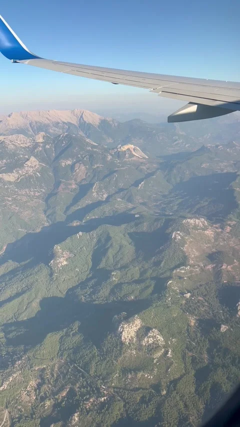 Scenery from a plane window flying over the mountains Stock Footage 337220791