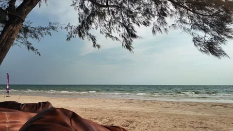 Scenery under the trees on a beautiful beach Stock Footage 274834385