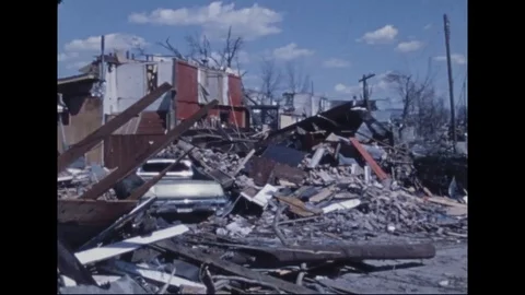 Scenes of destroyed homes, trees and rubble on car after tornado disaster - 1974 Stock Footage 97903696