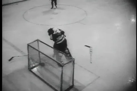 Scenes of fight between player and hockey game continues as crowd cheer - 1958 Stock Footage 99592094