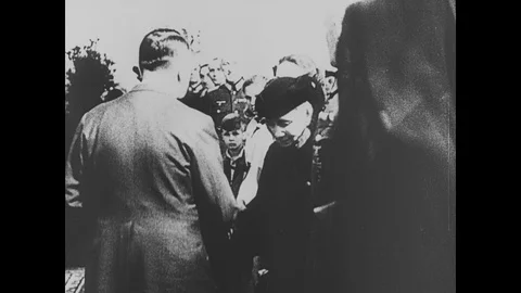 Scenes of Hitler comforts widow and children, funeral for soldier Stock Footage 109501229